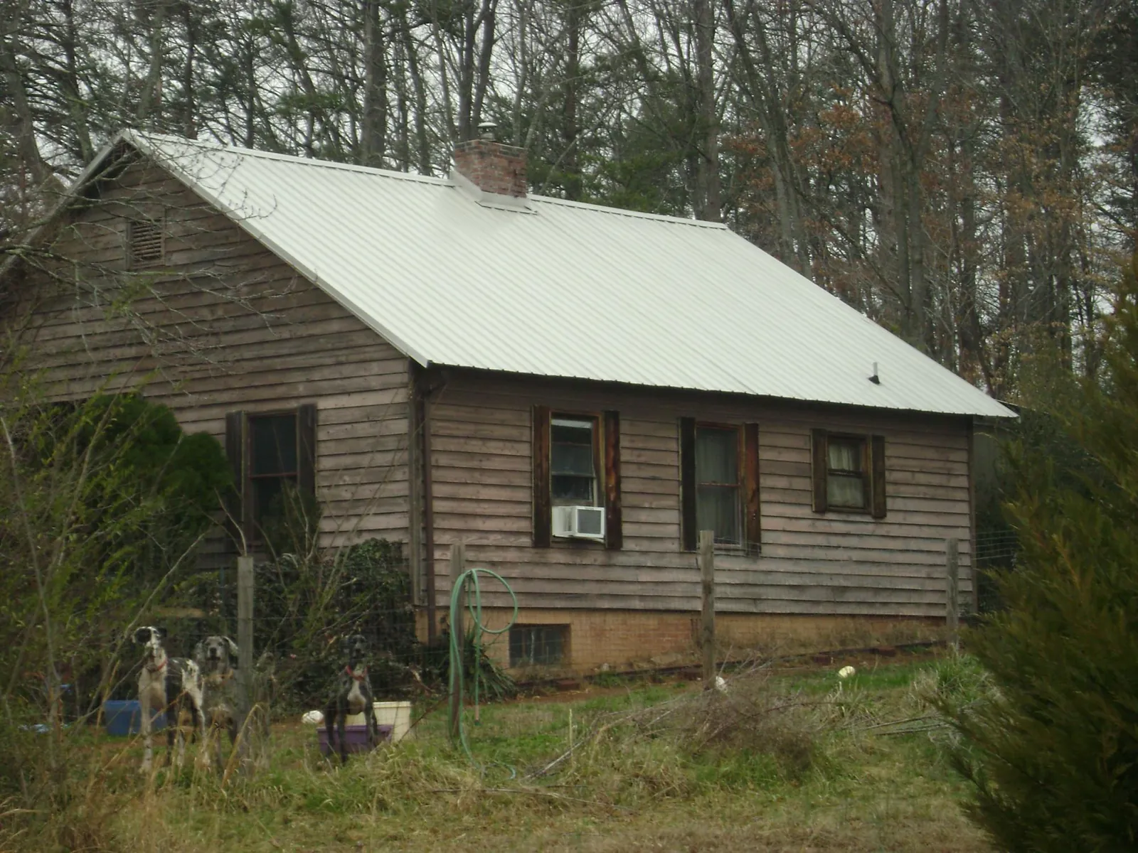 White metal roof on an old wood sided farmhouse, from a Metal Roof Installation job in South Park